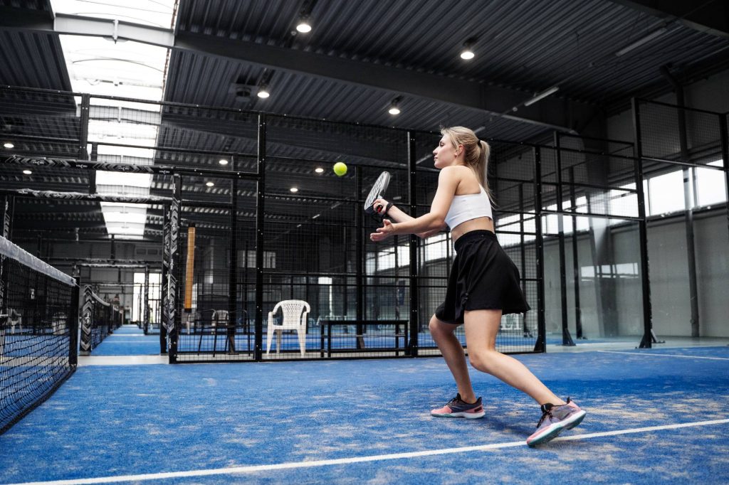 full-shot-fit-woman-playing-paddle-tennis