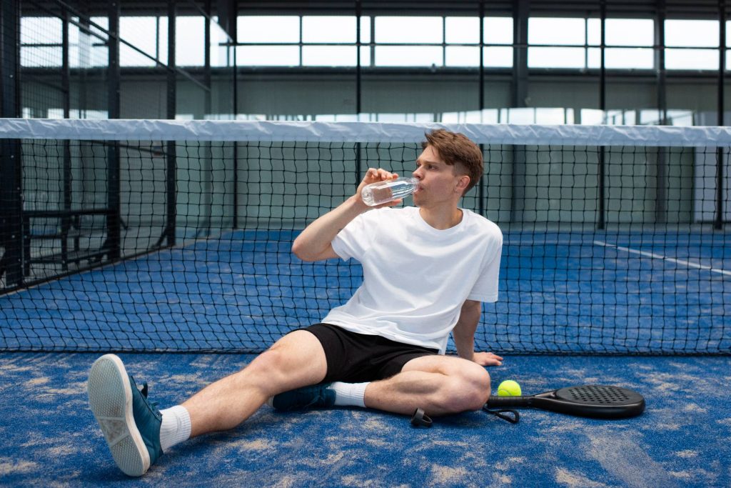 person-getting-ready-play-paddle-tennis-inside-1 person-getting-ready-play-paddle-tennis-inside-1